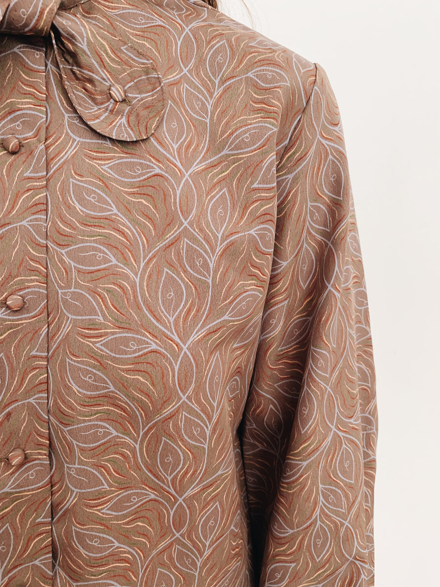 arlee park vintage tan twist-tie button neck blouse with a leaf pattern