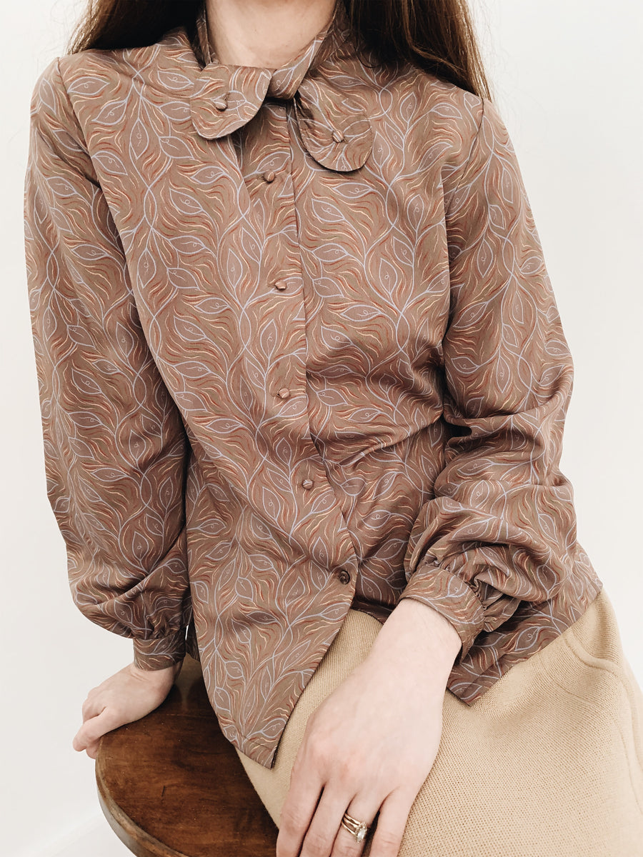 arlee park vintage tan twist-tie button neck blouse with a leaf pattern